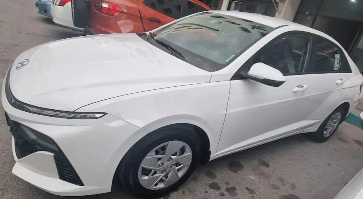منظر جانبي لسيارة هيونداي اكسنت 2026 بيضاء للتأجير في أبوظبي